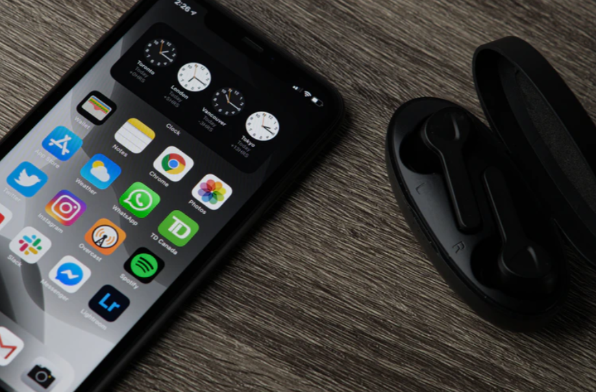 black iphone 5 on brown wooden table photo