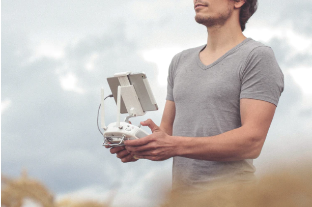 man holding white and gray drone controller photo – Free Human Image on Unsplash